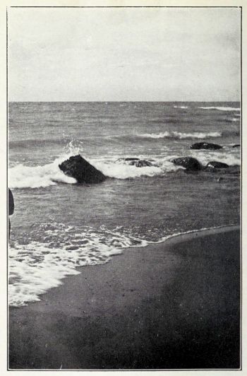 large rocks at water edge of beach