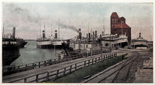 wood dock with paddle steamers alongside