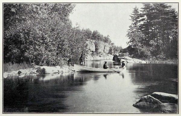 man in rowboat inside a channel