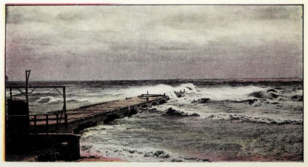 old wooden wharf being buffeted by waves