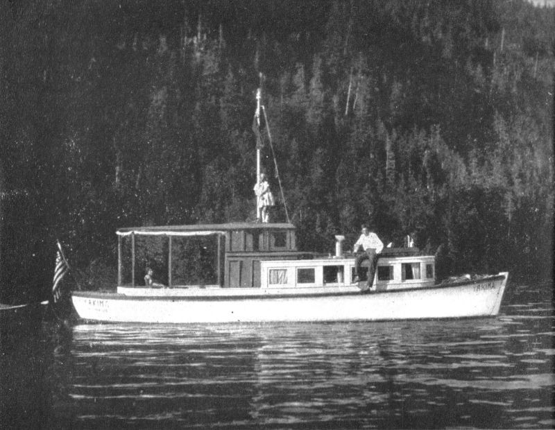 Photo of a thirty-six foot cruiser. A man is seated on the cabin roof while a woman is sitting in the aft part of the cruiser. A flag is flying in the stern.