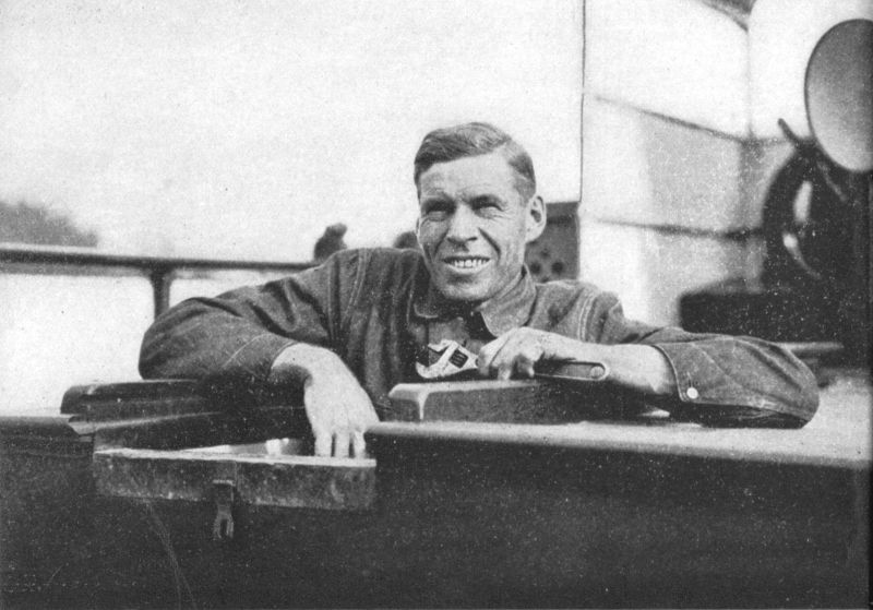 Photo of a smiling Robert from the shoulders up. He is holding a wrench in one hand and most likely working on the engine.