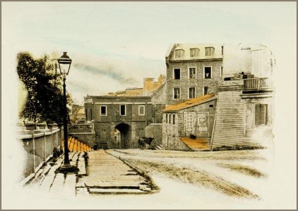 The image shows a narrow, stone street lined with old buildings, leading toward an arched passageway. A single gas lamp stands in the left foreground.