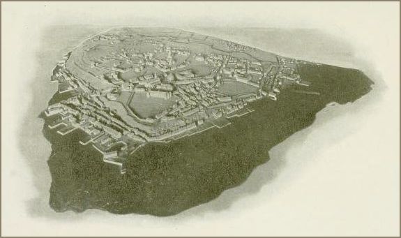Image shows a relief model depicting a fortified citadel with bastioned walls enclosing streets and buildings on elevated terrain.